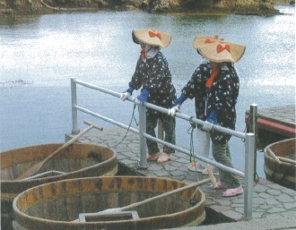 Fisherwomen and their taraibune around at harbor