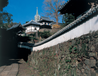 steeple-of-the-Francisco-de-Xavier-Church-behind-the-Buddhist-temples-of-Komyoji-and-Zuiunji