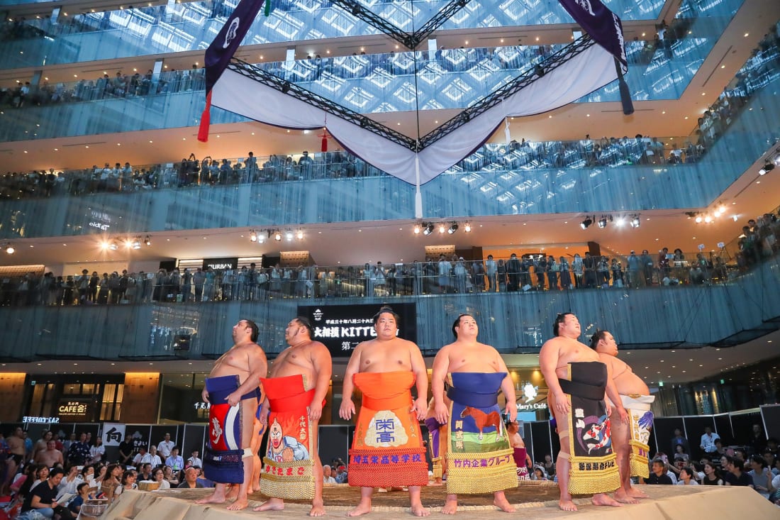 Sumo wrestlers at Kitte department store in Tokyo