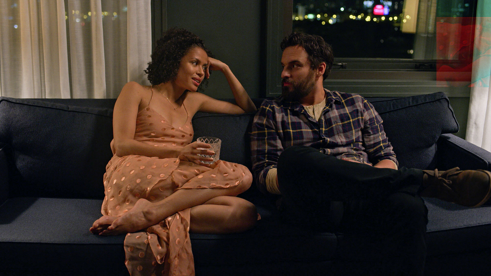 two african-americans sitting on a couch