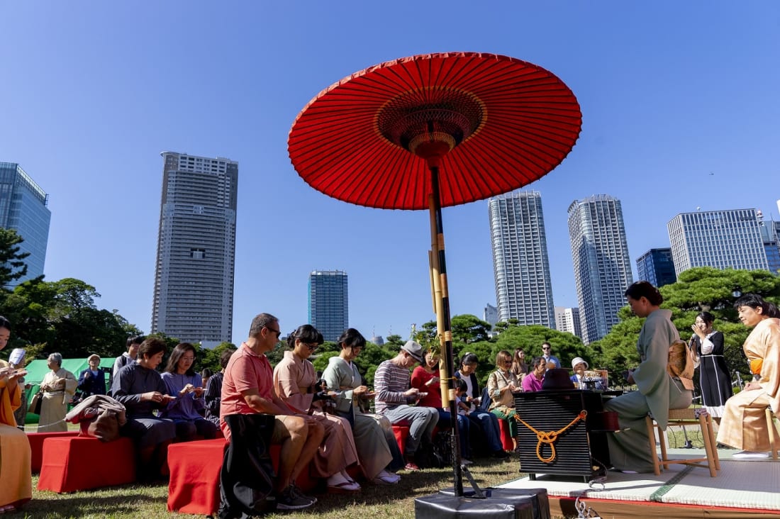 Foreign visitors participate at outdoor tea ceremony at Hamarikyu Gardens